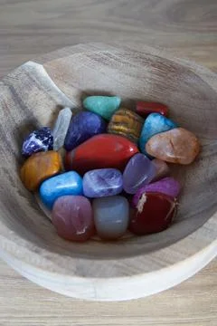 Different precious gem stones inside a wooden bowl Stock Photos