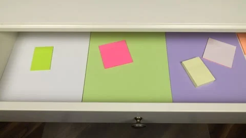 Different printer paper and note paper are laid out in a desk drawer Video stock 295032816