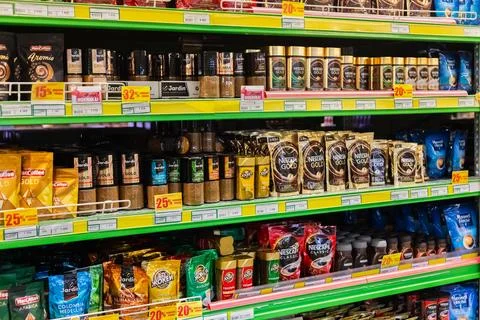 Different producers and types of coffee packaging on store shelves. grocery 스톡 사진