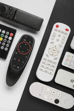 Different remote controllers on white and black background 库存照片
