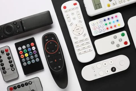 Different remote controllers on white and black background 库存照片