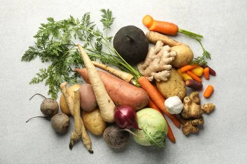 Different root vegetables on light grey table, flat lay Stock Photos