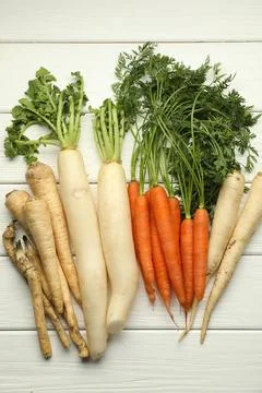 Different root vegetables on white wooden table, flat lay Stock Photos