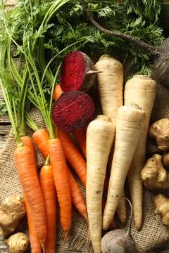 Different root vegetables on wooden table, flat lay Stock Photos