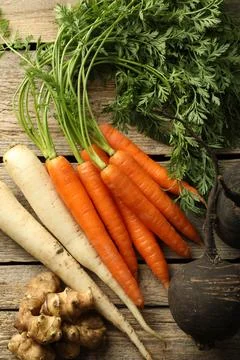 Different root vegetables on wooden table, flat lay Stock Photos