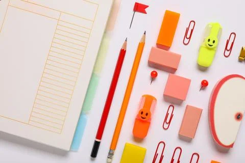 Different rubber erasers with notebook and stationery on white background Stock Photos
