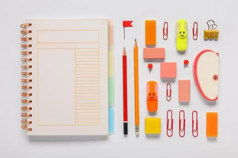 Different rubber erasers with notebook and stationery on white background Stock Photos