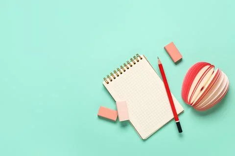 Different rubber erasers with notebook, pencil and sticky notes on turquoise  Stock Photos