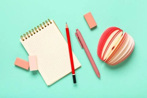 Different rubber erasers with notebook, pencil, pen and sticky notes on turqu Stock Photos