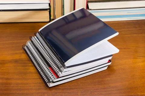 Different school exercise books stack on table against the books Fotos Stock