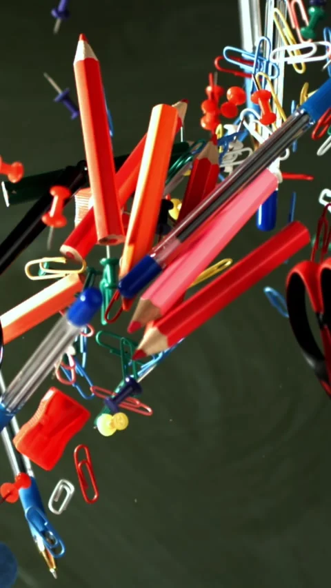 Different school objects fly and fall against the background of the blackboard Stock Footage 335366348