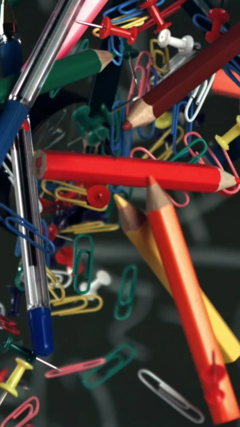 Different school objects fly and fall against the background of the blackboard Stock Footage 335371756