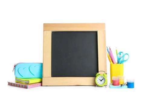 Different school stationery and small blank chalkboard on white background. S Stock Photos