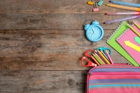 Different school stationery with space for design on wooden background, flat  库存照片