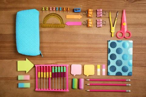 Different school stationery with space for design on wooden background, flat  Stock Photos