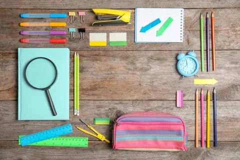 Different school stationery with space for design on wooden background, flat  Stock Photos