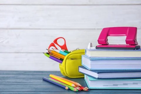 Different school stationery on table against light background Stock Photos