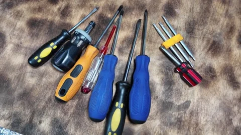 Different screwdrivers on the table. Flat and Phillips screwdrivers. Closeup ima Stock Footage 292384779
