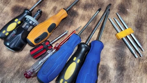 Different screwdrivers on the table. Flat and Phillips screwdrivers. Closeup ima Stock Footage 292385368