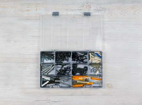 Different screws and nails in the box. Maintenance, reparing concept. Case wi Stock Photos