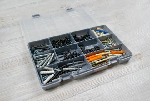 Different screws and nails in an open box. Maintenance, reparing concept. Cas Stock-Fotos