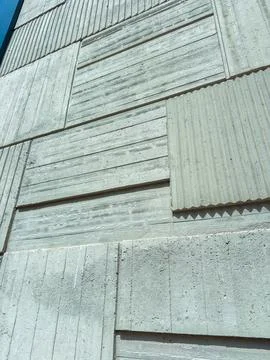 Different sections of a concrete wall display various textures and patterns.  Stock Photos