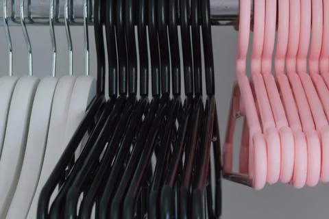 Different sets of clothes hangers in wardrobe of various shapes, materials .. Stock Photos