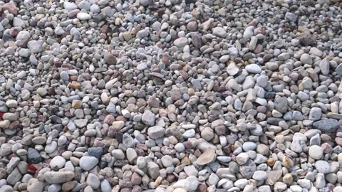Different shape and size pebbles pile at bright sunlight Stock Footage 139797940
