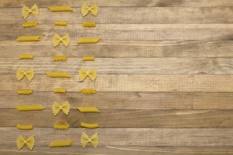 Different shape pasta chess order lay on wood Stock Photos