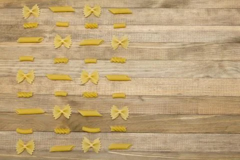 Different shape pasta chess order lay on wood Stock Photos