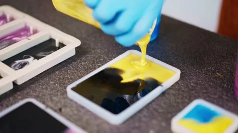 Different shapes of silicone molds for epoxy resin samples, craftsman in Stock-Footage 263144717