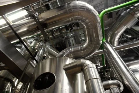 Different size and shaped pipes and valves at a power plant Stock Photos