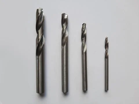 Different size drill bits isolated in white Stock Photos