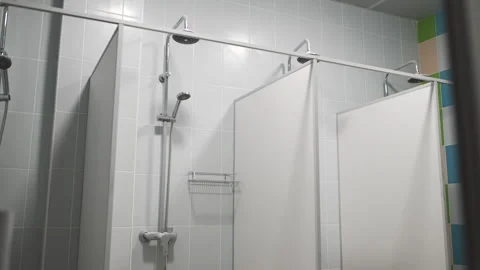 Different size heads in cabins of empty public shower Stock Footage 291327551