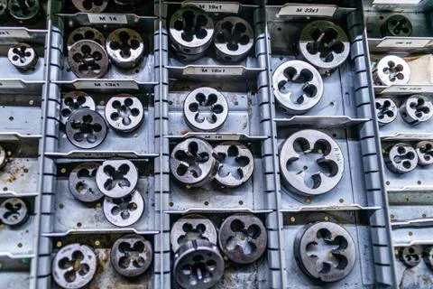 Different size sorted Thread cutting die tool, a photo close up. Industrial a Stock Photos