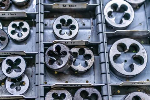 Different size sorted Thread cutting die tool, a photo close up. Industrial a Stock Photos
