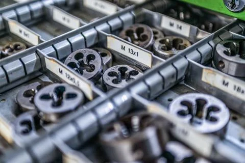 Different size sorted Thread cutting die tool, a photo close up. Industrial a Stock Photos