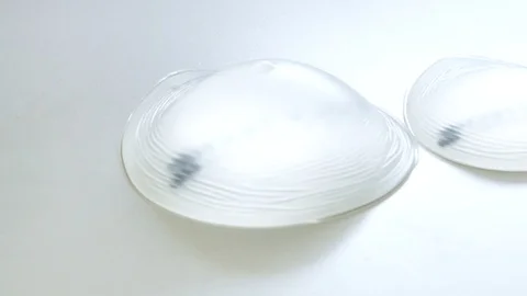 Different sized breast implants on the table at beauty clinic. Stock Footage 95212477