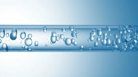 Different sized bubbles flowing in glass tube with clear liquid Stock Footage 167168019