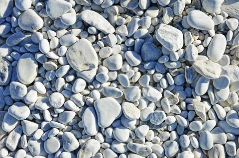 Different sized oval and round marble pebbles on the coast of the Ligurian Se Stock Photos