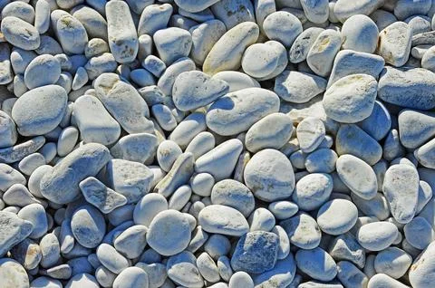 Different sized oval and round marble pebbles on the coast of the Ligurian Se Stock Photos