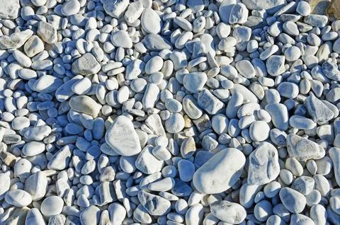 Different sized oval and round marble pebbles on the coast of the Ligurian Se Stock Photos