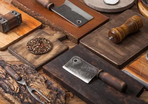 Different sizes and shapes kitchen chopping boards on wooden background Stock Photos