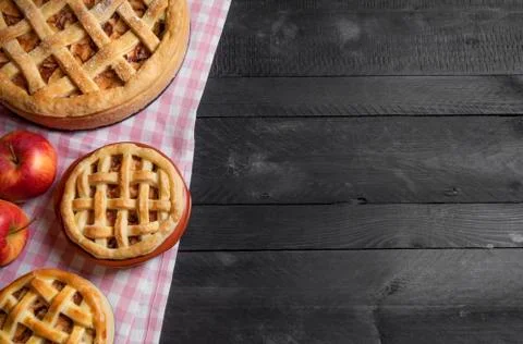 Different sizes apple pies on a rustic table. Above view with copy space. Stock Photos
