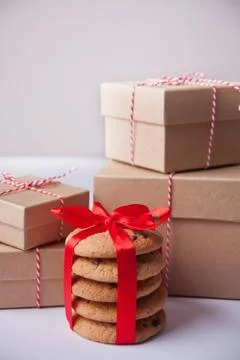 Different sizes Christmas gift boxes, homemade cookies for present on the lig Stock Photos