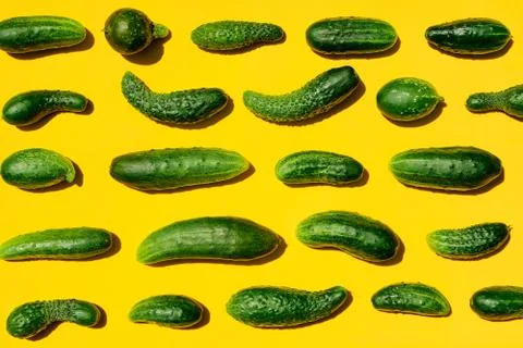 Different sizes forms cucumbers pattern on a light yellow background. Copy sp Stockfoto's