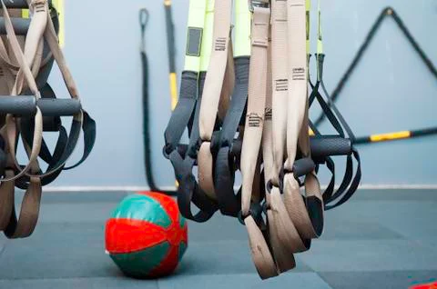 Different sizes of kettlebells weights lying on gym floor. Equipment commonly Stock Photos
