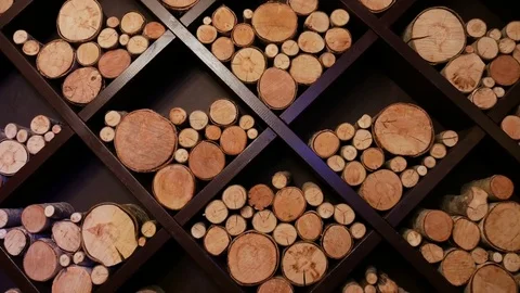 Different sizes of logs lie on a square shelves for the decoration Stock Footage 84974390