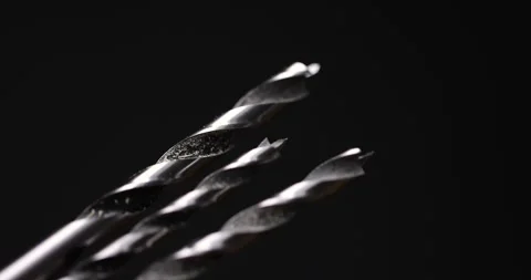 Different sizes of metal drills on a black background, metal drill for wood Stock Footage 281042679