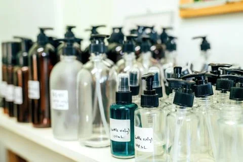 Different sizes pumping and spray bottles, recycling materials in a shop. Zero Stock Photos